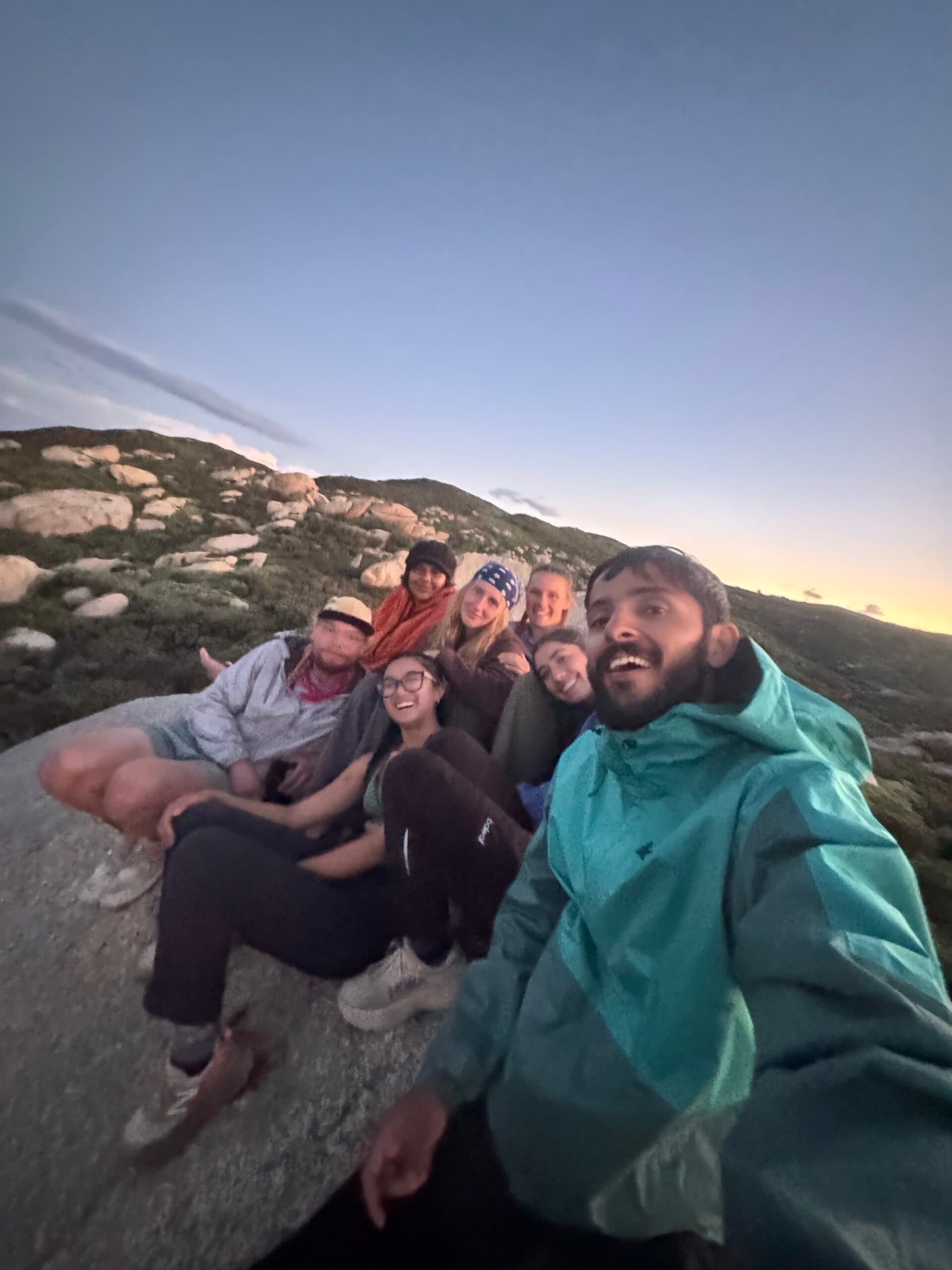 Backpackers posing together on a desert ridge in Southern California