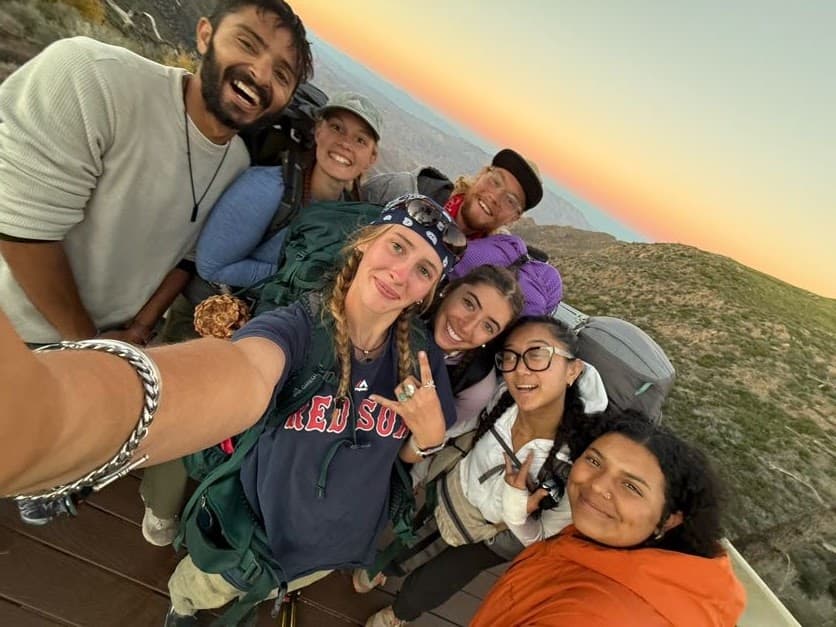 A group of backpackers at a Pacific Crest Trail monument