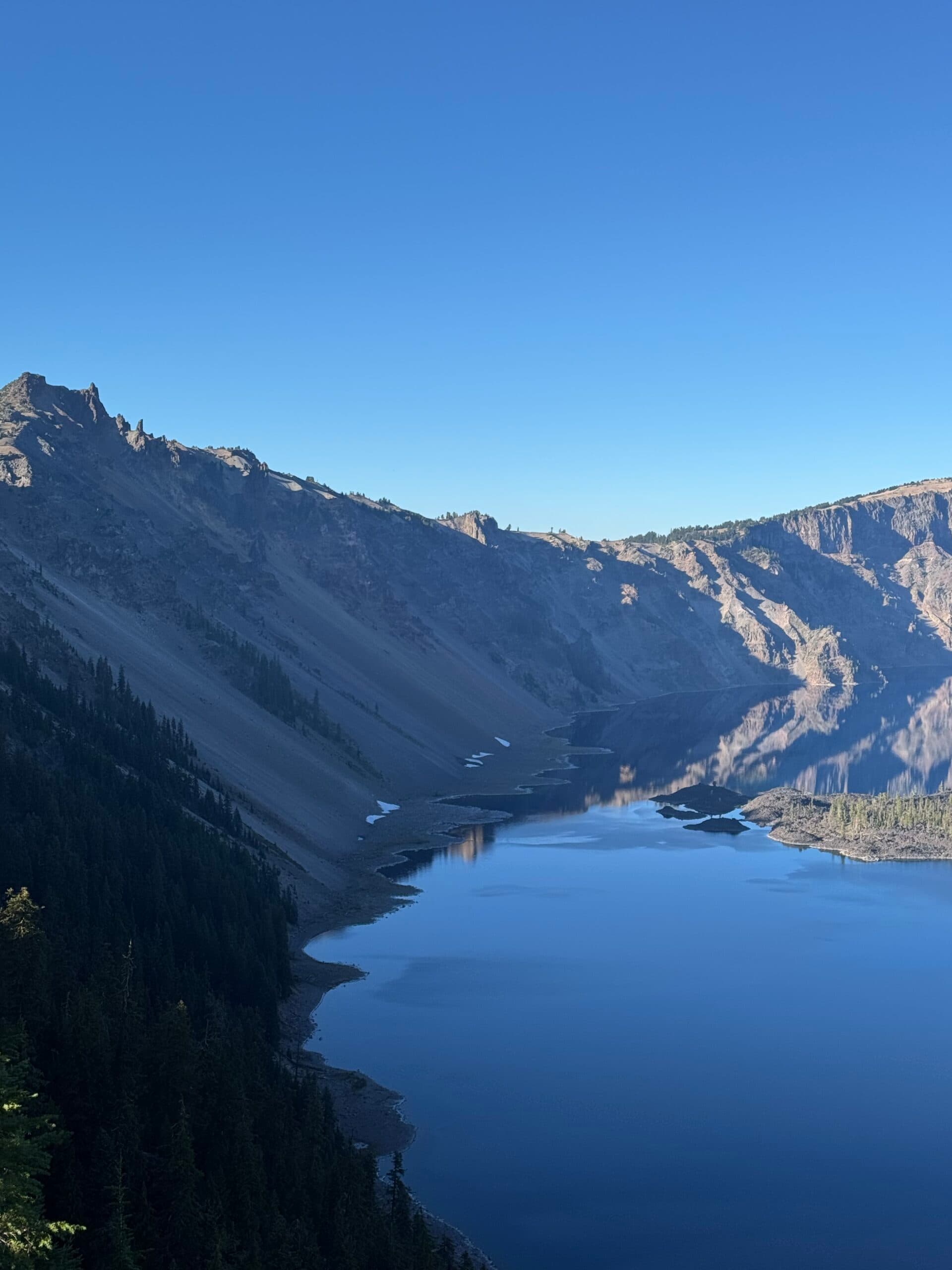Alpine lake and forested mountains along the Pacific Crest Trail at sunset